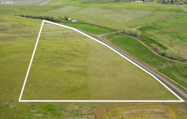 birds eye view of property with a rural view