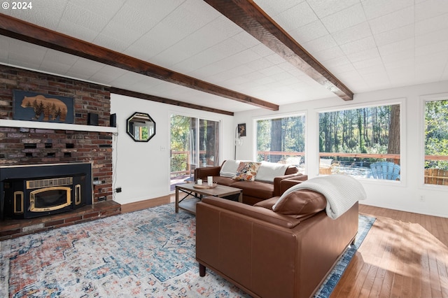 living room featuring hardwood / wood-style floors, beamed ceiling, and plenty of natural light