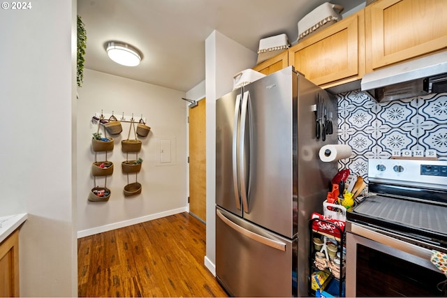 kitchen featuring light hardwood / wood-style floors, range hood, light brown cabinetry, and stainless steel appliances