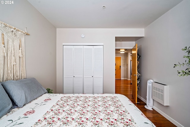 bedroom with a closet and dark hardwood / wood-style flooring