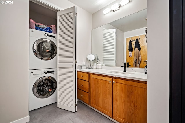 clothes washing area with sink and stacked washer and dryer