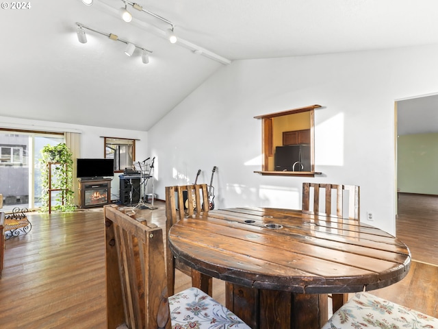 dining area with hardwood / wood-style floors and vaulted ceiling