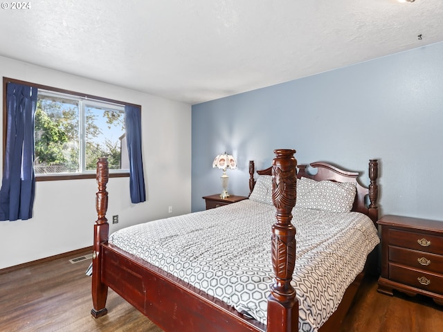 bedroom featuring a textured ceiling and wood-type flooring