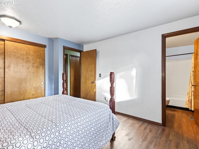 bedroom featuring hardwood / wood-style floors and a textured ceiling