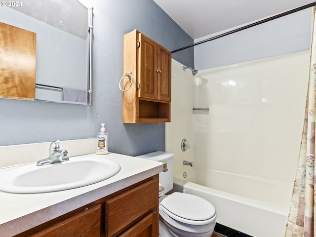 full bathroom with vanity, shower / tub combo, and toilet