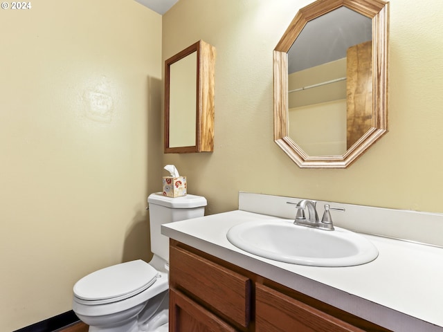 bathroom featuring toilet and vanity