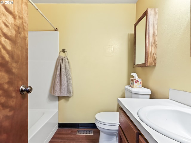 full bathroom featuring vanity, toilet, wood-type flooring, and tub / shower combination