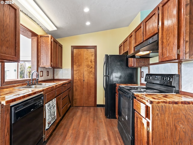 kitchen featuring black appliances, sink, a textured ceiling, lofted ceiling, and dark hardwood / wood-style floors