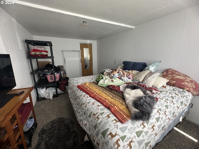 carpeted bedroom featuring a textured ceiling