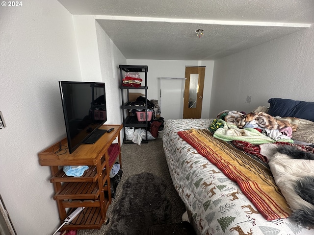 carpeted bedroom featuring a textured ceiling