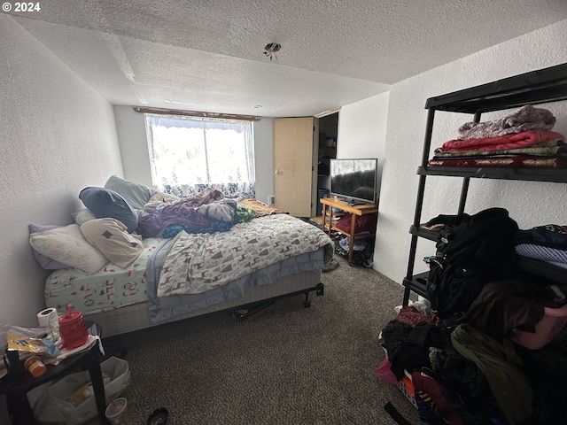 carpeted bedroom with a textured ceiling