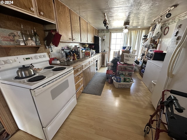 kitchen featuring backsplash, ceiling fan, light wood-type flooring, and white electric stove