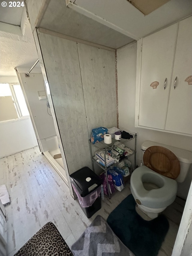 bathroom featuring a shower and wood-type flooring