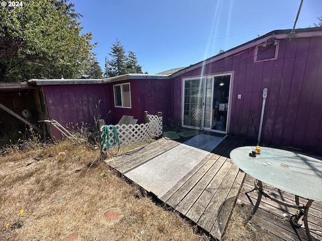 rear view of house featuring a deck