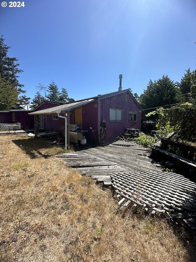 back of house with a deck