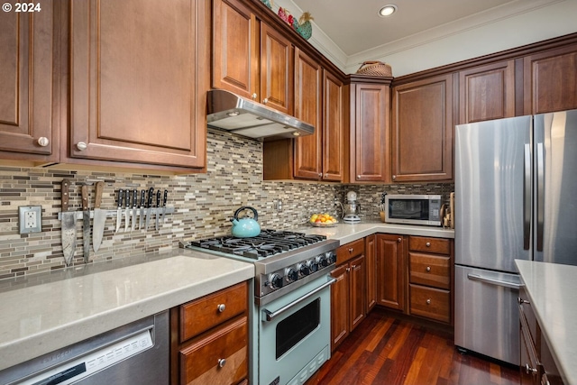 kitchen with appliances with stainless steel finishes, ornamental molding, backsplash, and dark hardwood / wood-style floors