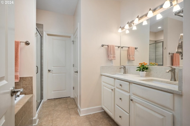 bathroom featuring a shower with door, tile patterned flooring, and vanity