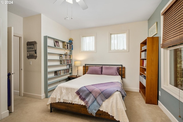 bedroom with ceiling fan and light carpet