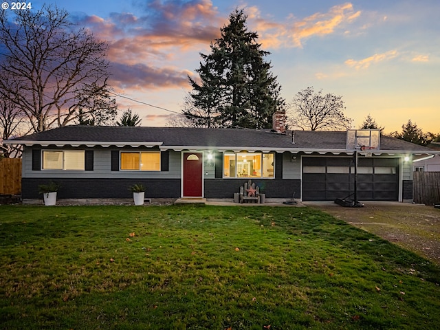 ranch-style home with a yard