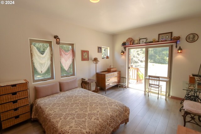 bedroom featuring hardwood / wood-style flooring and access to outside