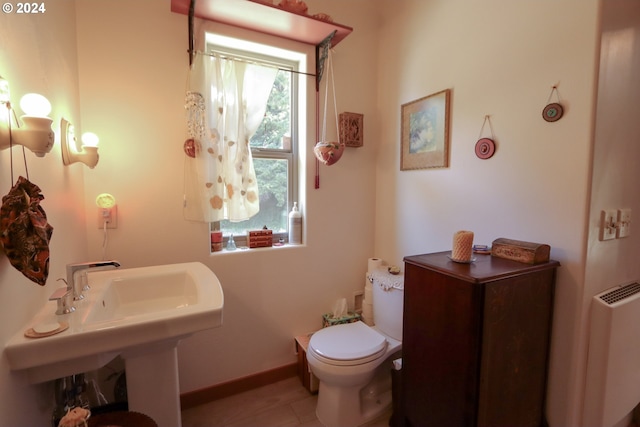 bathroom featuring toilet and tile patterned floors