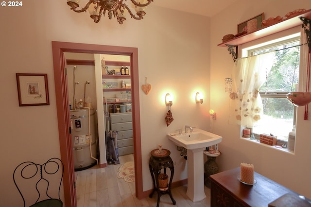 interior space featuring hardwood / wood-style floors, sink, and strapped water heater