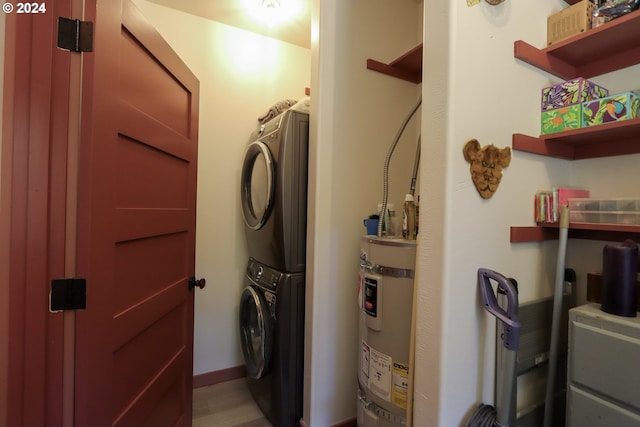 utility room featuring stacked washer / drying machine and secured water heater