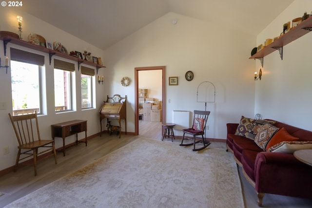 living area featuring hardwood / wood-style floors and vaulted ceiling