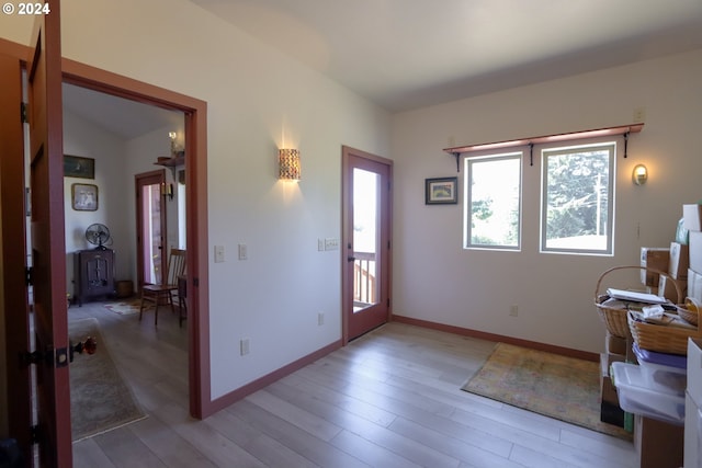 entryway with lofted ceiling and hardwood / wood-style flooring