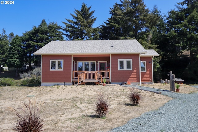 bungalow-style home featuring a porch and a shingled roof