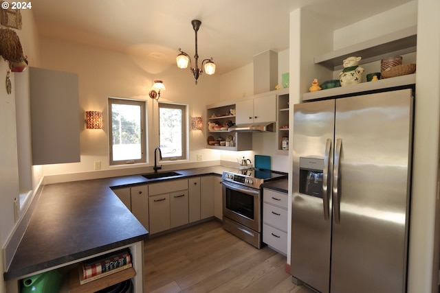 kitchen with dark hardwood / wood-style floors, an inviting chandelier, decorative light fixtures, stainless steel appliances, and sink