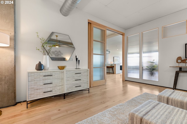 sitting room with light hardwood / wood-style floors and french doors