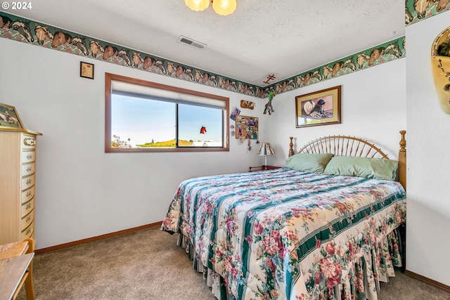 carpeted bedroom featuring a textured ceiling