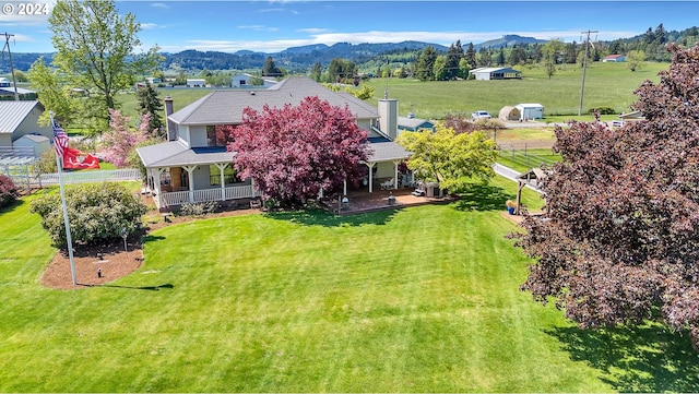 birds eye view of property with a mountain view