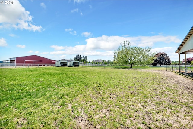 view of yard featuring a rural view and an outdoor structure