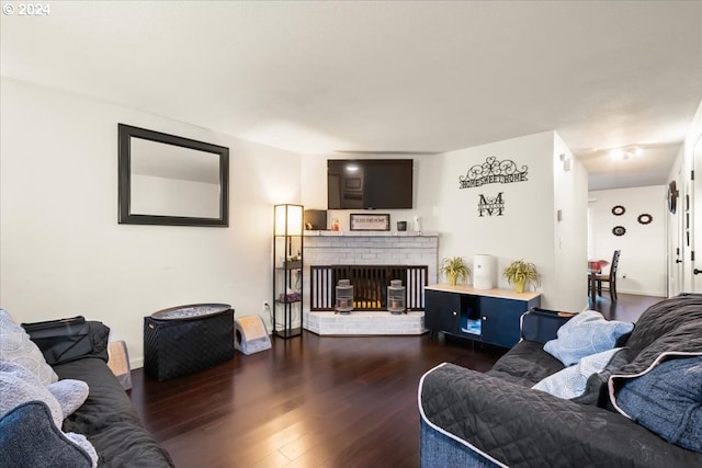 living room featuring a fireplace and dark hardwood / wood-style floors