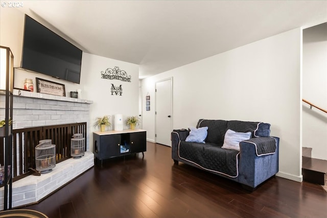 living room featuring a fireplace and dark hardwood / wood-style floors