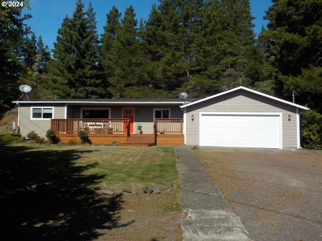 ranch-style home with a front yard, a garage, and a wooden deck