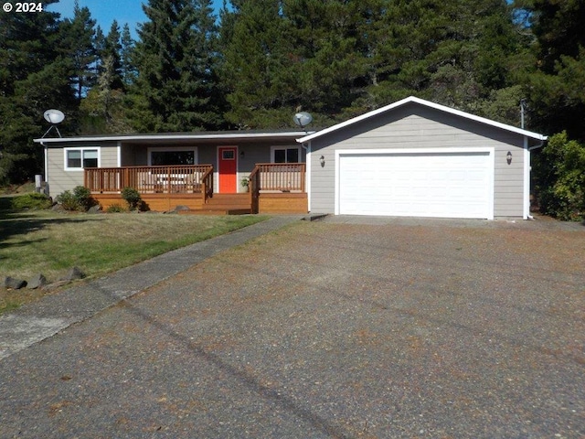 single story home with a garage, a deck, and a front lawn