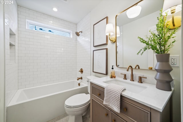 full bathroom with vanity, toilet, and tiled shower / bath combo