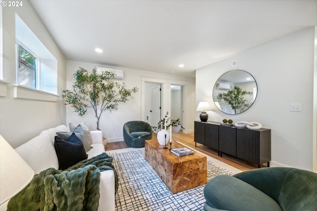 living room featuring a wall unit AC and hardwood / wood-style flooring