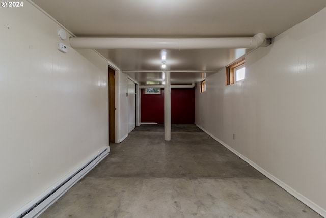 interior space featuring concrete flooring and a baseboard radiator