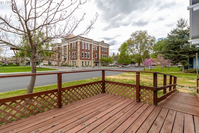 wooden terrace featuring a yard