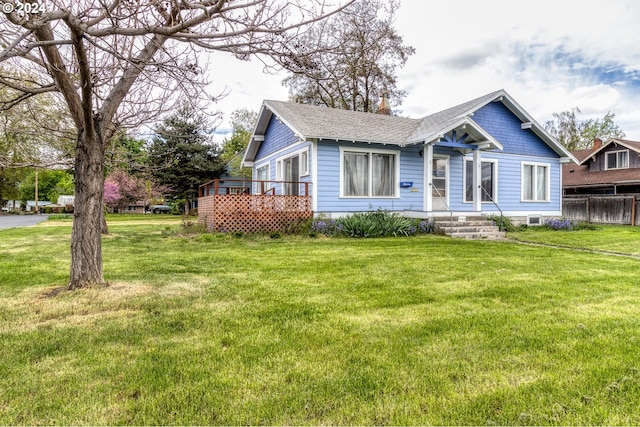 view of front of property with a front lawn and a deck