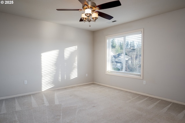 carpeted empty room featuring ceiling fan