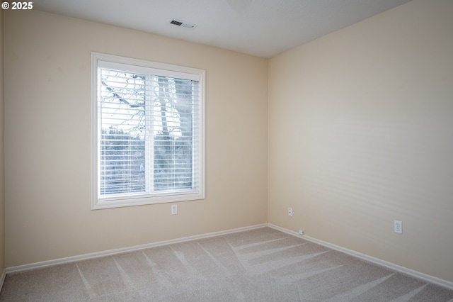 unfurnished room with light colored carpet