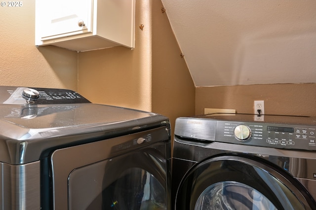 clothes washing area with cabinets and independent washer and dryer