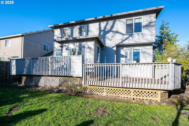 rear view of property with a deck and a lawn