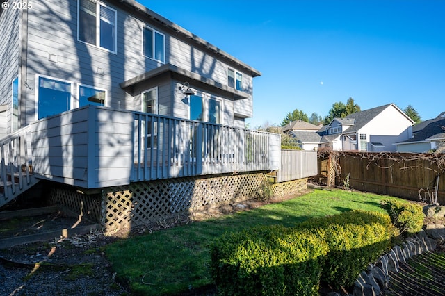 back of house with a lawn and a deck