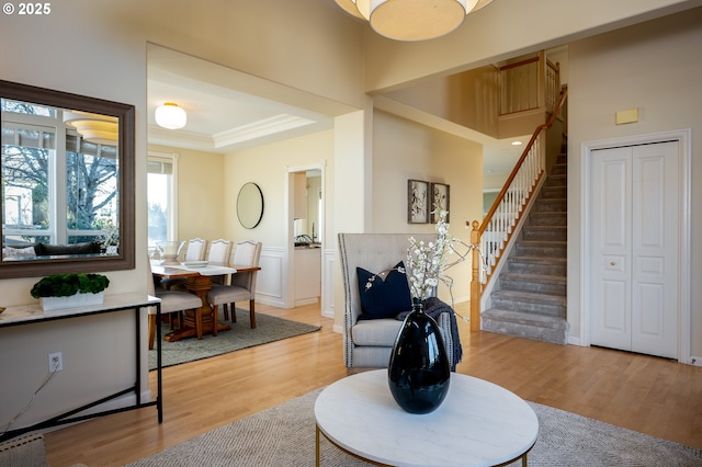 living room with ornamental molding and wood-type flooring